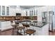 Gourmet kitchen features white cabinets, granite counters, stainless appliances, breakfast bar, and decorative backsplash at 3503 W Price Ave, Tampa, FL 33611
