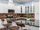 Bright kitchen boasts white cabinets, granite counters, stainless appliances, breakfast bar, and decorative backsplash at 3503 W Price Ave, Tampa, FL 33611
