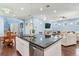 Bright kitchen with granite counters, stainless appliances, and island with sink overlooking the dining and living room areas at 3503 W Price Ave, Tampa, FL 33611