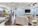 Open-concept living room features a kitchen island with counter seating and hardwood floors at 3503 W Price Ave, Tampa, FL 33611
