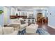 Open concept living room with hardwood floors, fireplace, and comfortable seating, adjacent to a gourmet kitchen area at 3503 W Price Ave, Tampa, FL 33611