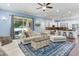 Bright living room with hardwood floors and comfortable seating, adjacent to a gourmet kitchen area at 3503 W Price Ave, Tampa, FL 33611