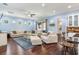 Spacious living room with hardwood floors and comfortable seating, adjacent to a modern kitchen area at 3503 W Price Ave, Tampa, FL 33611