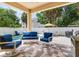 Covered patio with comfortable blue cushioned seating overlooking a pool at 3503 W Price Ave, Tampa, FL 33611