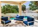Covered patio features blue cushioned seating overlooking a pool with a water feature at 3503 W Price Ave, Tampa, FL 33611