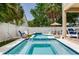 Relaxing backyard oasis showcasing a sparkling pool with a built-in spa and cozy fire features at 3503 W Price Ave, Tampa, FL 33611
