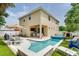 A spacious backyard features a pool, patio seating area, and lush landscaping perfect for outdoor entertaining at 3503 W Price Ave, Tampa, FL 33611