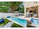 Inviting backyard oasis with a sparkling pool, covered patio, and outdoor kitchen at 3503 W Price Ave, Tampa, FL 33611