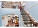 View of the staircase landing with hardwood floors that opens to the kitchen and dining area at 3503 W Price Ave, Tampa, FL 33611