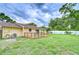 A spacious backyard with a wood deck and a well maintained lawn at 40019 Pretty Redbird Rd, Zephyrhills, FL 33540
