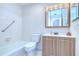 Full bathroom with tiled shower-tub and wood vanity at 40019 Pretty Redbird Rd, Zephyrhills, FL 33540