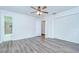 Neutral bedroom with hardwood floors, large closet, and ensuite bathroom at 40019 Pretty Redbird Rd, Zephyrhills, FL 33540