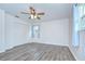Spacious bedroom features updated ceiling fan, wood-look floors and neutral paint at 40019 Pretty Redbird Rd, Zephyrhills, FL 33540