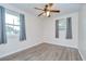 Bright bedroom features updated ceiling fan, wood-look floors and neutral paint at 40019 Pretty Redbird Rd, Zephyrhills, FL 33540