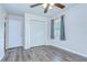 Cozy bedroom with hardwood style floor, closet, single window, and paneled door at 40019 Pretty Redbird Rd, Zephyrhills, FL 33540