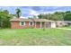 Cozy brick home with well maintained lawn, traditional windows, and a single-car garage at 40019 Pretty Redbird Rd, Zephyrhills, FL 33540