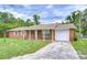 Charming brick home featuring a single-car garage and a well-manicured lawn at 40019 Pretty Redbird Rd, Zephyrhills, FL 33540