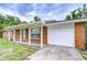 Lovely brick home featuring a covered front porch and attached one car garage, offering convenience and classic style at 40019 Pretty Redbird Rd, Zephyrhills, FL 33540