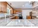 Modern kitchen featuring granite countertops, stainless steel appliances, and a cozy breakfast bar at 40019 Pretty Redbird Rd, Zephyrhills, FL 33540