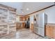 Well-lit kitchen boasts stainless steel appliances, wood cabinetry, and granite countertops at 40019 Pretty Redbird Rd, Zephyrhills, FL 33540
