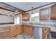 Beautiful kitchen boasting wood cabinetry, stainless steel appliances, and a convenient breakfast bar at 40019 Pretty Redbird Rd, Zephyrhills, FL 33540