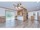 Spacious open-concept living area featuring wood-look floors and a modern, updated kitchen at 40019 Pretty Redbird Rd, Zephyrhills, FL 33540