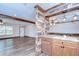 Open-concept living area with wood-look flooring and view of the kitchen's breakfast bar at 40019 Pretty Redbird Rd, Zephyrhills, FL 33540
