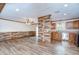 Spacious living room and kitchen featuring hardwood floors and abundant natural light at 40019 Pretty Redbird Rd, Zephyrhills, FL 33540