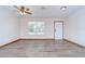 Bright living room with new floors, ceiling fan, and lots of natural light at 40019 Pretty Redbird Rd, Zephyrhills, FL 33540