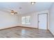 Bright living room with new floors, ceiling fan, and lots of natural light at 40019 Pretty Redbird Rd, Zephyrhills, FL 33540
