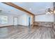 Bright living room featuring wood-look floors and plenty of natural light at 40019 Pretty Redbird Rd, Zephyrhills, FL 33540