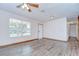 Bright living room with new floors, ceiling fan, and lots of natural light at 40019 Pretty Redbird Rd, Zephyrhills, FL 33540
