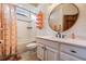Bright bathroom featuring a vanity, toilet, tub, and shower with flamingo patterned shower curtain at 4400 English Turn Way, Wesley Chapel, FL 33543