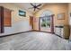 Spacious bedroom featuring tile floors, ceiling fan, and a large window with curtains at 4400 English Turn Way, Wesley Chapel, FL 33543