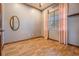 Neutral bedroom with wood flooring, large window, and pink curtains at 4400 English Turn Way, Wesley Chapel, FL 33543
