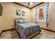 Cozy bedroom with warm paint, wood flooring, and large window at 4400 English Turn Way, Wesley Chapel, FL 33543