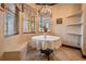 Bright breakfast nook with window seating and an elegant chandelier fixture overhead at 4400 English Turn Way, Wesley Chapel, FL 33543