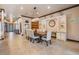 Bright dining area displays elegant chandelier, tile floors, and natural lighting at 4400 English Turn Way, Wesley Chapel, FL 33543