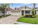 Charming single-Gathering home features a well-maintained lawn, brick driveway, and attached two-car garage at 4400 English Turn Way, Wesley Chapel, FL 33543