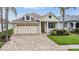 Charming home with a well-manicured lawn, lush landscaping, and a welcoming paver driveway, set in a desirable neighborhood at 4400 English Turn Way, Wesley Chapel, FL 33543