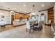 Open-concept kitchen and dining area with ample cabinets, countertop space, and tile flooring at 4400 English Turn Way, Wesley Chapel, FL 33543