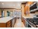 Charming kitchen features an island sink, wood cabinets, breakfast nook, and stainless steel appliances at 4400 English Turn Way, Wesley Chapel, FL 33543