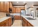 Well-equipped kitchen features stainless steel appliances, plentiful wood cabinetry, and stone countertops at 4400 English Turn Way, Wesley Chapel, FL 33543