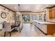 Open kitchen and dining area with quartz countertops, stainless appliances, and access to the patio at 4400 English Turn Way, Wesley Chapel, FL 33543