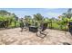 Outdoor patio featuring comfortable seating arranged around a fire pit with landscaping view at 4400 English Turn Way, Wesley Chapel, FL 33543