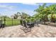 Patio with comfortable chairs surrounding a fire pit with lush landscaping view at 4400 English Turn Way, Wesley Chapel, FL 33543