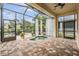 Relaxing screened patio with hot tub, overhead lighting, and comfortable seating at 4400 English Turn Way, Wesley Chapel, FL 33543
