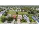 A lovely street view of three homes in a community with well-manicured lawns and mature landscaping at 4400 English Turn Way, Wesley Chapel, FL 33543