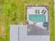 Aerial view featuring a screened-in pool and well-maintained roof of the home at 4419 Gaston St, Spring Hill, FL 34607