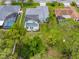 Stunning aerial view of a home with a screened-in pool, lush landscaping, and a serene outdoor living space at 4419 Gaston St, Spring Hill, FL 34607